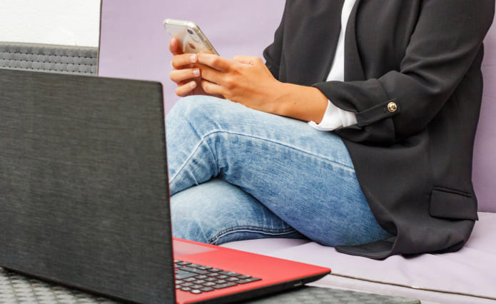 A woman typing on her cell phone